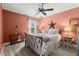 Comfortable bedroom with large windows, plush carpet, and warm coral paint at 357 Ridgewood Trl, Canton, GA 30115