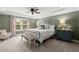 Comfortable primary bedroom with tray ceilings, carpeted floors, and large windows at 357 Ridgewood Trl, Canton, GA 30115