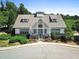 Charming clubhouse with a stone foundation, gray roof, white siding, and a welcoming covered entryway with patriotic bunting at 357 Ridgewood Trl, Canton, GA 30115