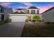 Inviting two-story home featuring a manicured lawn and a convenient two-car garage at 357 Ridgewood Trl, Canton, GA 30115