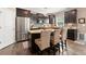 Modern kitchen with stainless steel appliances, granite countertops, dark wood cabinets, a breakfast bar with seating at 357 Ridgewood Trl, Canton, GA 30115