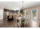 Modern kitchen with stainless steel appliances, dark wood cabinets, tile backsplash, a dining table and chairs at 357 Ridgewood Trl, Canton, GA 30115