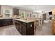 Open kitchen with stainless steel appliances, granite countertops, and dark wood cabinets flowing into the dining and living areas at 357 Ridgewood Trl, Canton, GA 30115