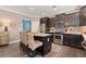 Well-equipped kitchen with stainless steel appliances, granite countertops, dark wood cabinets, and a breakfast bar with seating at 357 Ridgewood Trl, Canton, GA 30115