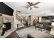 Open-concept living area with stone fireplace, hardwood floors, and seamless dining area at 357 Ridgewood Trl, Canton, GA 30115