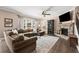 Bright living room boasts a stone fireplace, hardwood floors, and comfortable seating at 357 Ridgewood Trl, Canton, GA 30115
