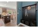 Mud room with coat rack and basket storage, connecting to the open concept kitchen and dining area at 357 Ridgewood Trl, Canton, GA 30115