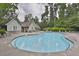 A kidney-shaped pool surrounded by lounge chairs and a nearby changing cabana at 357 Ridgewood Trl, Canton, GA 30115