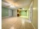 Large basement area featuring tiled floors, a kitchenette and drop ceiling at 4003 Preston Place Ln, Powder Springs, GA 30127