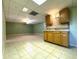 Spacious basement area with tiled floors, kitchenette and drop ceiling at 4003 Preston Place Ln, Powder Springs, GA 30127