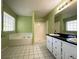 Bright bathroom featuring a soaking tub, separate shower, and double sink vanity at 4003 Preston Place Ln, Powder Springs, GA 30127