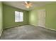 Bedroom features neutral walls, ceiling fan, plush carpeting, and a window providing natural light at 4003 Preston Place Ln, Powder Springs, GA 30127