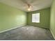 Cozy bedroom with soft carpeting, ceiling fan, and a large window offering natural light at 4003 Preston Place Ln, Powder Springs, GA 30127