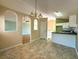 Bright dining area featuring an open layout, stylish lighting, and seamless transition to the kitchen at 4003 Preston Place Ln, Powder Springs, GA 30127