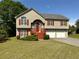 Charming two-story home with a well-maintained lawn, red shutters, and a two car garage at 4003 Preston Place Ln, Powder Springs, GA 30127