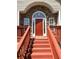 Inviting front porch with stone accents, painted steps, and a classic red front door at 4003 Preston Place Ln, Powder Springs, GA 30127