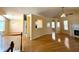 Spacious open-concept living room with hardwood floors, fireplace, and arched openings at 4003 Preston Place Ln, Powder Springs, GA 30127