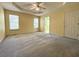 Spacious main bedroom featuring a ceiling fan, large windows, and plush carpeting at 4003 Preston Place Ln, Powder Springs, GA 30127