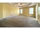 Spacious main bedroom with neutral walls, plush carpeting, and two windows offering natural light at 4003 Preston Place Ln, Powder Springs, GA 30127