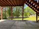Covered outdoor patio featuring concrete flooring and wooden support beams at 4003 Preston Place Ln, Powder Springs, GA 30127