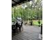 Spacious back deck with outdoor dining area, providing scenic views of the surrounding wooded landscape at 7350 Banks Mill Rd, Douglasville, GA 30135