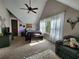 Charming bedroom with sloped ceilings, a ceiling fan, natural light, and vintage decor, offering a cozy retreat at 7350 Banks Mill Rd, Douglasville, GA 30135