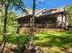 Stunning home exterior with a wrap-around porch and manicured lawn at 7350 Banks Mill Rd, Douglasville, GA 30135