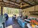 Inviting covered patio with outdoor seating and ceiling fan at 7350 Banks Mill Rd, Douglasville, GA 30135