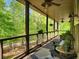 Covered porch with wooded view and comfortable outdoor seating at 7350 Banks Mill Rd, Douglasville, GA 30135