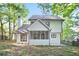 Back exterior of a well-maintained two-story home with a screened-in porch and a chimney at 275 Carriage Chase, Fayetteville, GA 30214