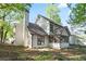 Two-story home featuring a screened in porch, chimney, and mature trees providing shade at 275 Carriage Chase, Fayetteville, GA 30214