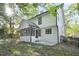 Two-story home featuring a screened in porch and a spacious backyard with mature trees at 275 Carriage Chase, Fayetteville, GA 30214