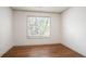 Empty bedroom features hardwood floors, white walls, and a bright window with natural light at 275 Carriage Chase, Fayetteville, GA 30214