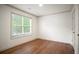 Empty bedroom features wood floors, crown molding, a window with blinds, and a white door at 275 Carriage Chase, Fayetteville, GA 30214