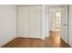 Empty bedroom with wood flooring, white walls, and access to an en-suite bathroom at 275 Carriage Chase, Fayetteville, GA 30214