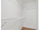 Walk-in closet with built-in white wire shelving and laminate wood flooring, offering ample storage space at 275 Carriage Chase, Fayetteville, GA 30214