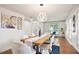 Elegant dining room with stylish lighting, white chairs, and modern artwork at 275 Carriage Chase, Fayetteville, GA 30214