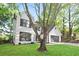 Exterior view of a lovely two-story home with a lush front yard and large trees at 275 Carriage Chase, Fayetteville, GA 30214