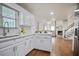 Open kitchen view with white cabinets, hardwood floors, and sight lines to living room at 275 Carriage Chase, Fayetteville, GA 30214