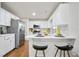 Bright, modern kitchen with white cabinets, stainless steel appliances, and breakfast bar at 275 Carriage Chase, Fayetteville, GA 30214