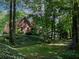 Secluded backyard view with trees and greenery surrounding the beautiful home at 5900 Fords Nw Rd, Acworth, GA 30101