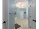 Hallway shot to bathroom featuring large soaking tub with tile flooring and blue wall paint at 5900 Fords Nw Rd, Acworth, GA 30101
