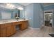 Bathroom features double vanity, tile flooring, large mirrors, and soft blue wall paint at 5900 Fords Nw Rd, Acworth, GA 30101