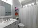 Bright bathroom features white vanity, decorative mirror, tile flooring and bathtub with shower at 5900 Fords Nw Rd, Acworth, GA 30101