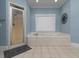 Bright bathroom with a large soaking tub, tiled floor, and a glass shower at 5900 Fords Nw Rd, Acworth, GA 30101
