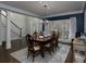Formal dining room with dark hardwood floors, crown molding, and large windows offering natural light at 5900 Fords Nw Rd, Acworth, GA 30101