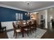 Inviting dining room with blue accent wall, hardwood floors, and elegant chandelier at 5900 Fords Nw Rd, Acworth, GA 30101