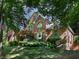 Beautiful two-story brick home featuring a landscaped front yard and inviting arched entryway at 5900 Fords Nw Rd, Acworth, GA 30101