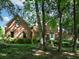 Charming brick home with an arched entry, surrounded by lush landscaping and mature trees at 5900 Fords Nw Rd, Acworth, GA 30101