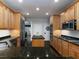 Modern kitchen with granite countertops, stainless steel appliances, and maple cabinets at 5900 Fords Nw Rd, Acworth, GA 30101